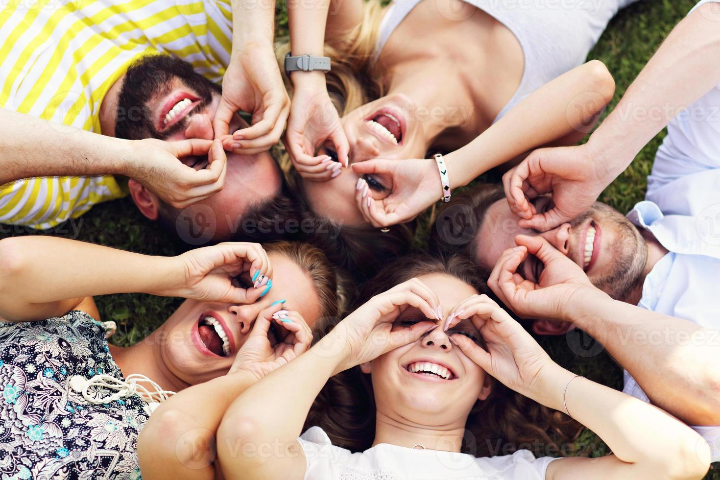 Friends group having fun together on grass photo