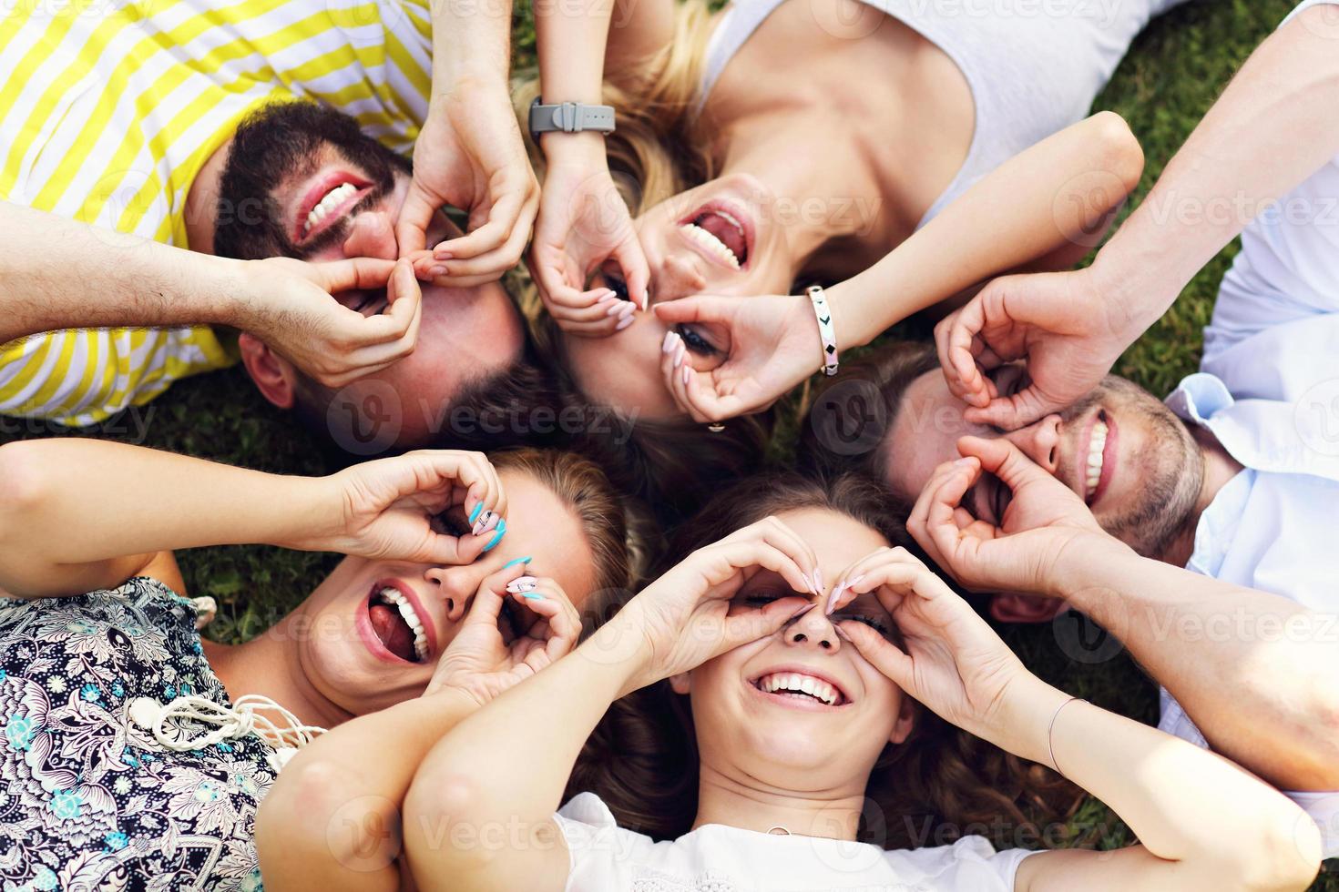 Friends group having fun together on grass photo