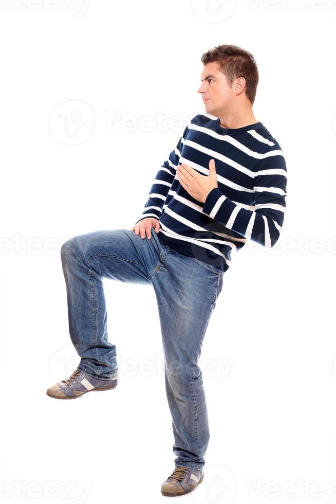 Young man standing on one leg photo