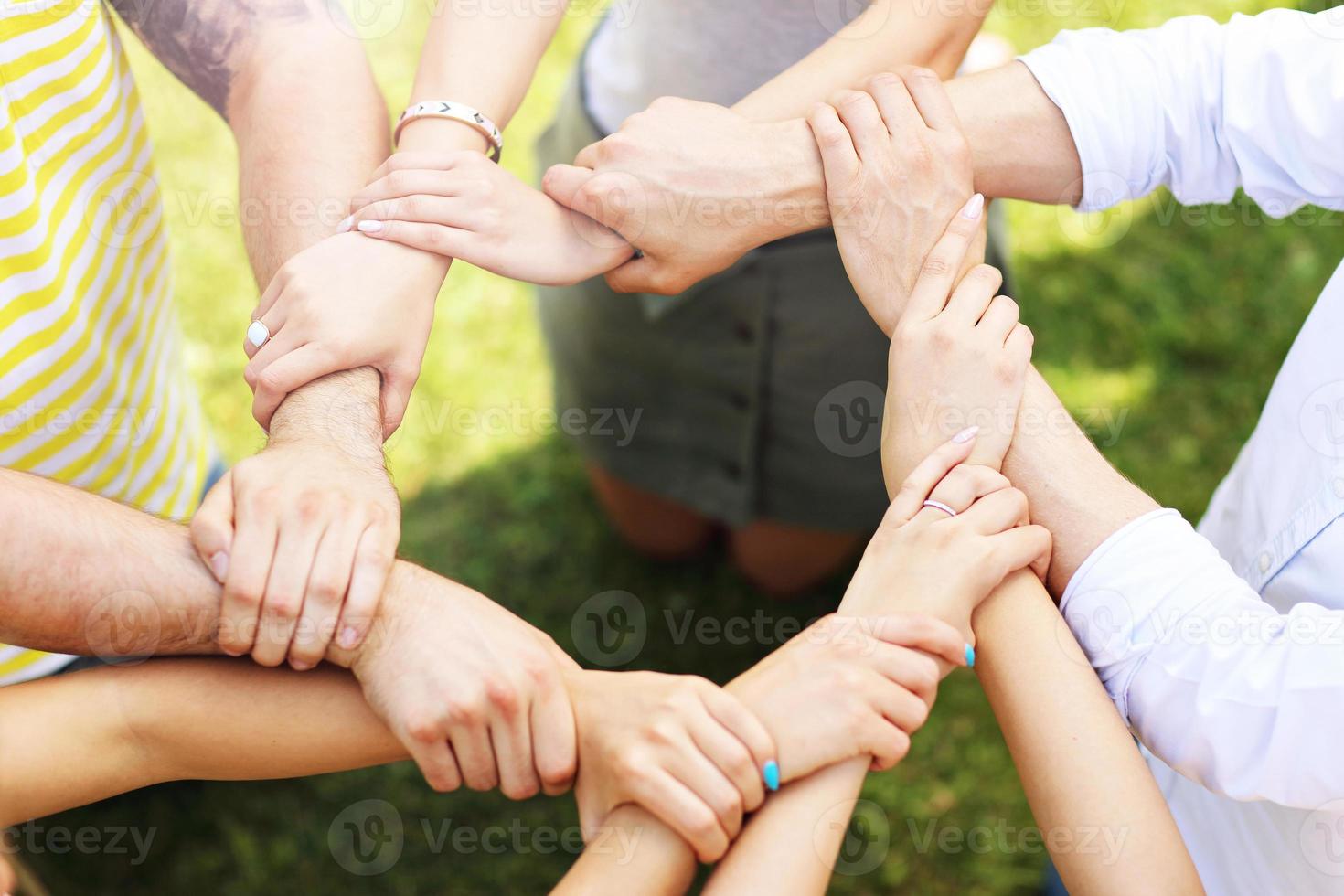 Friends group having fun together on grass photo