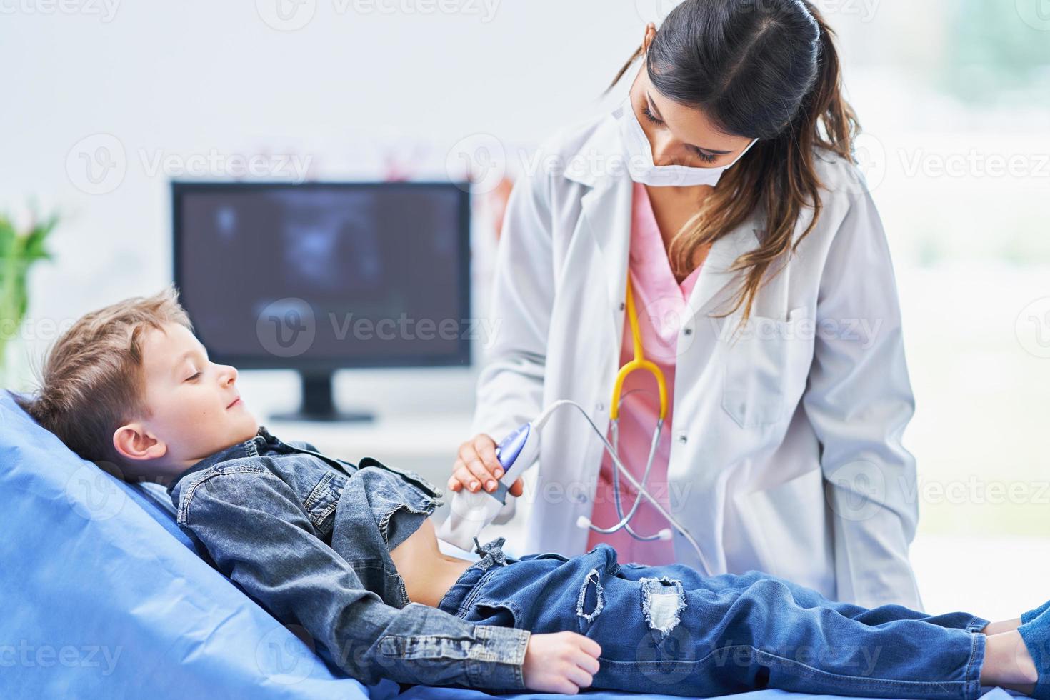 Little boy having USG examination by pediatrician photo