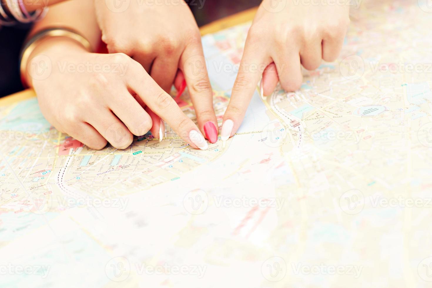 Fingers pointing at map photo