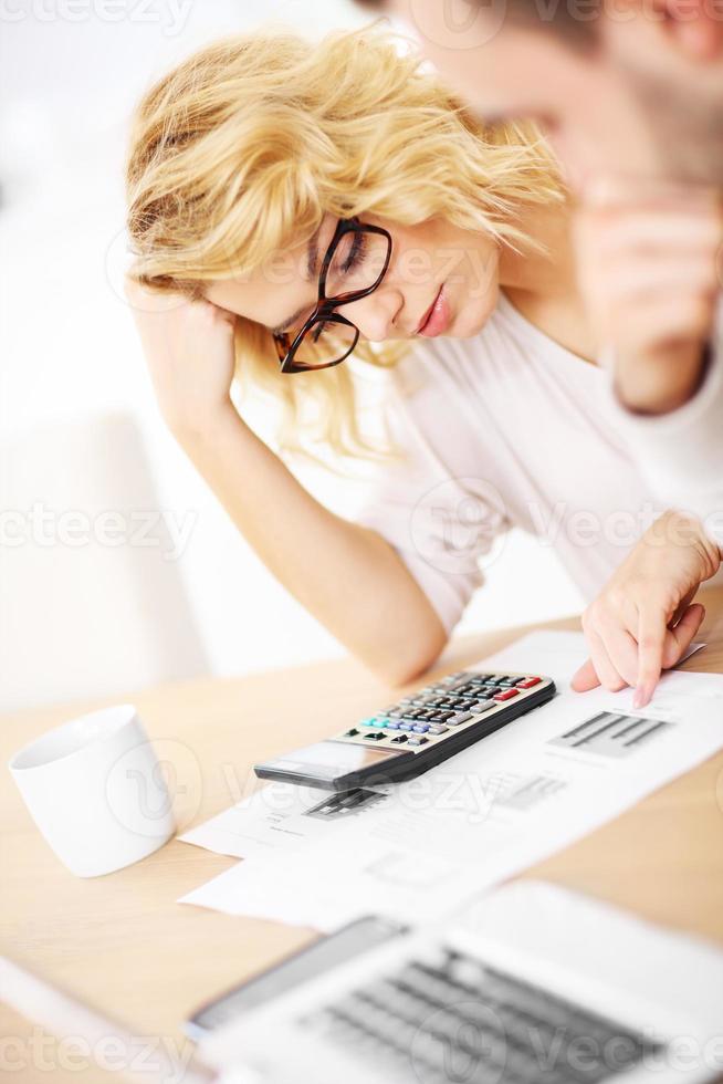 Unhappy couple with documents at home photo