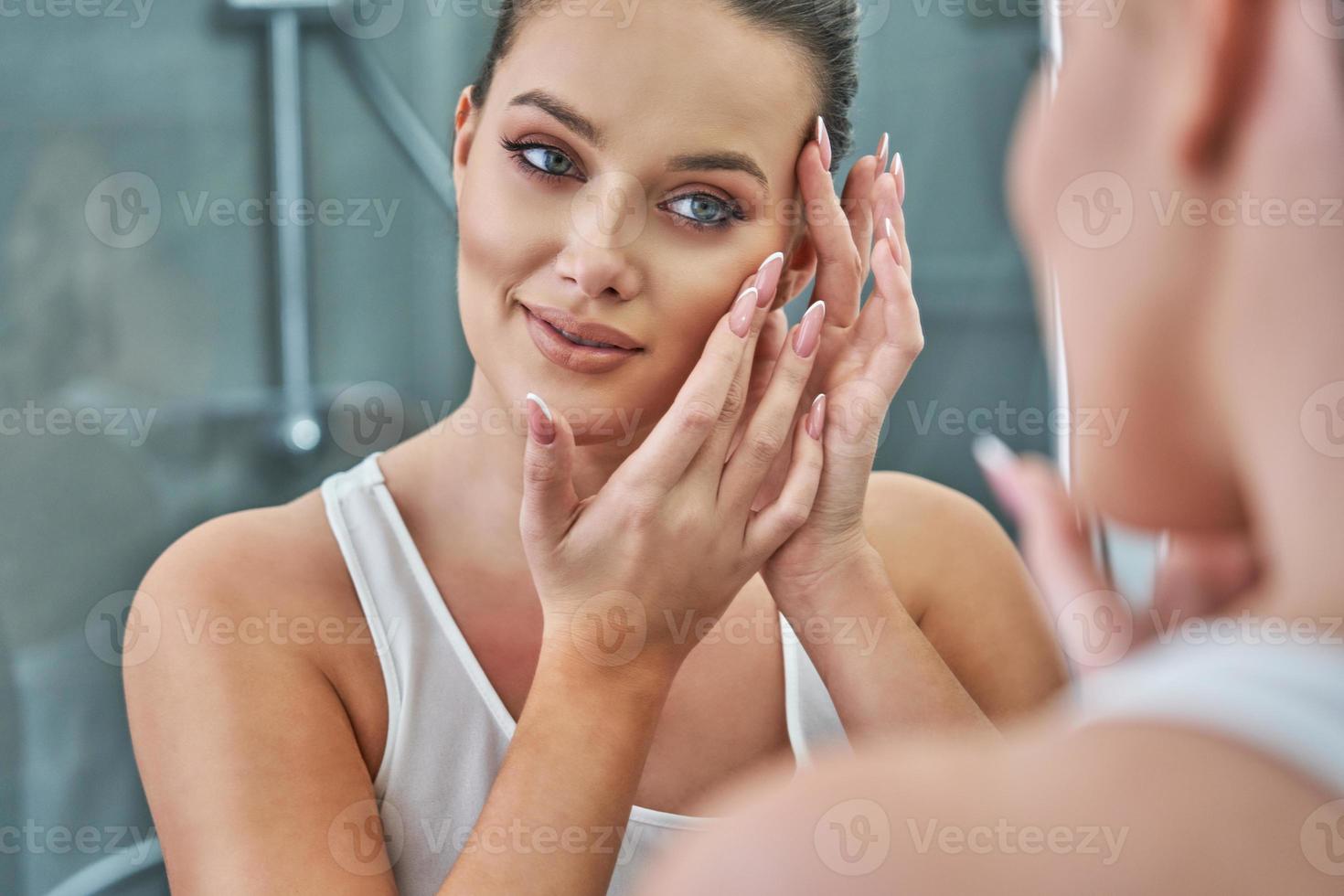 Woman looking on reflection in the mirror after shower 15853630 Stock