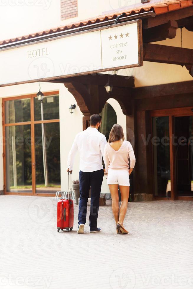 Pretty couple entering hotel photo