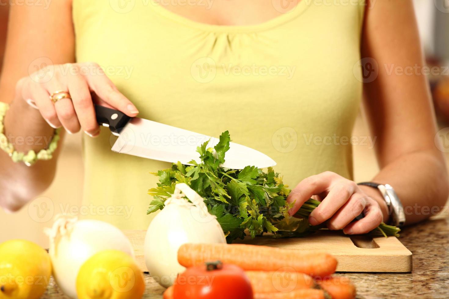 Young wife cutting parsley photo