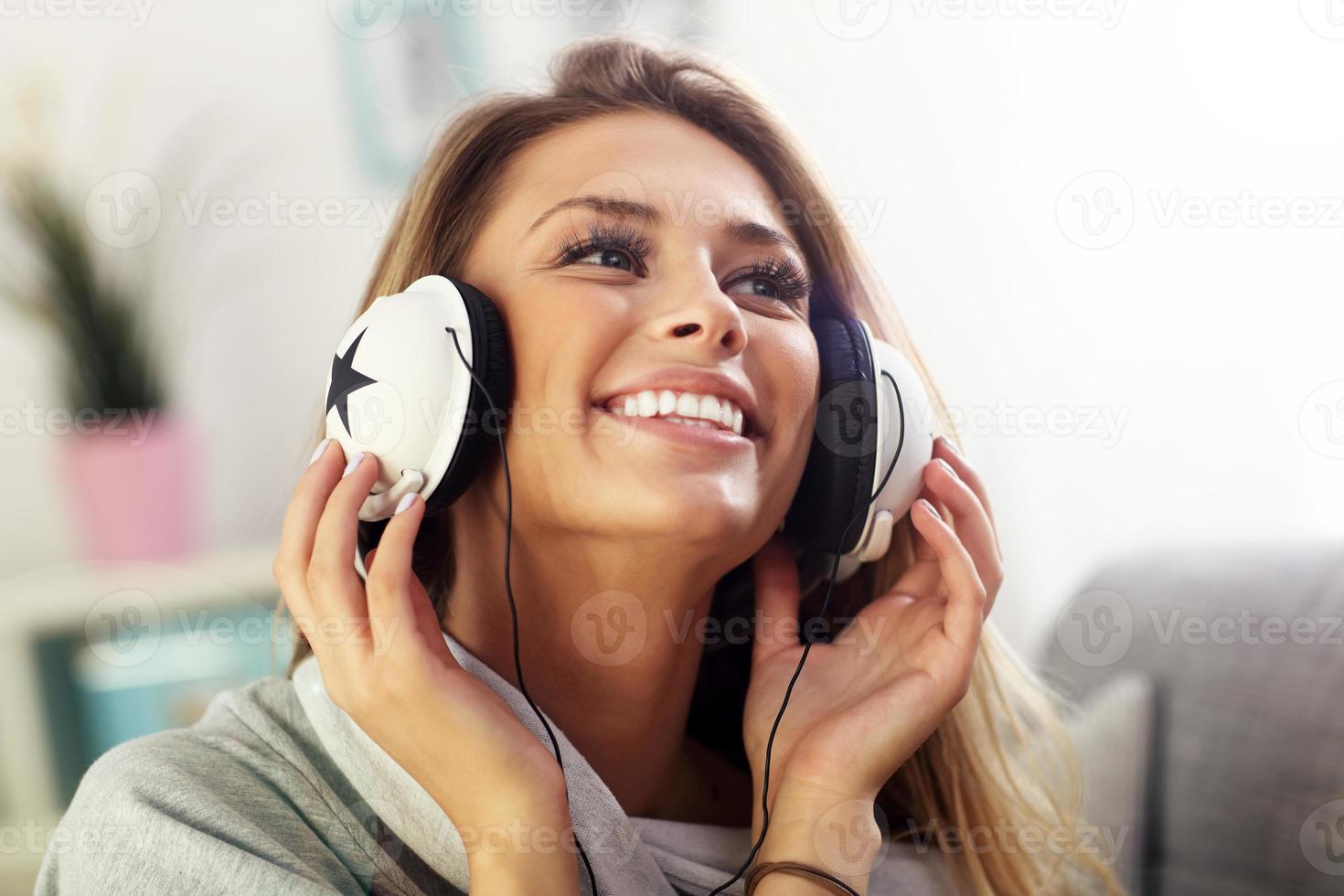 Happy woman listening to music at home photo