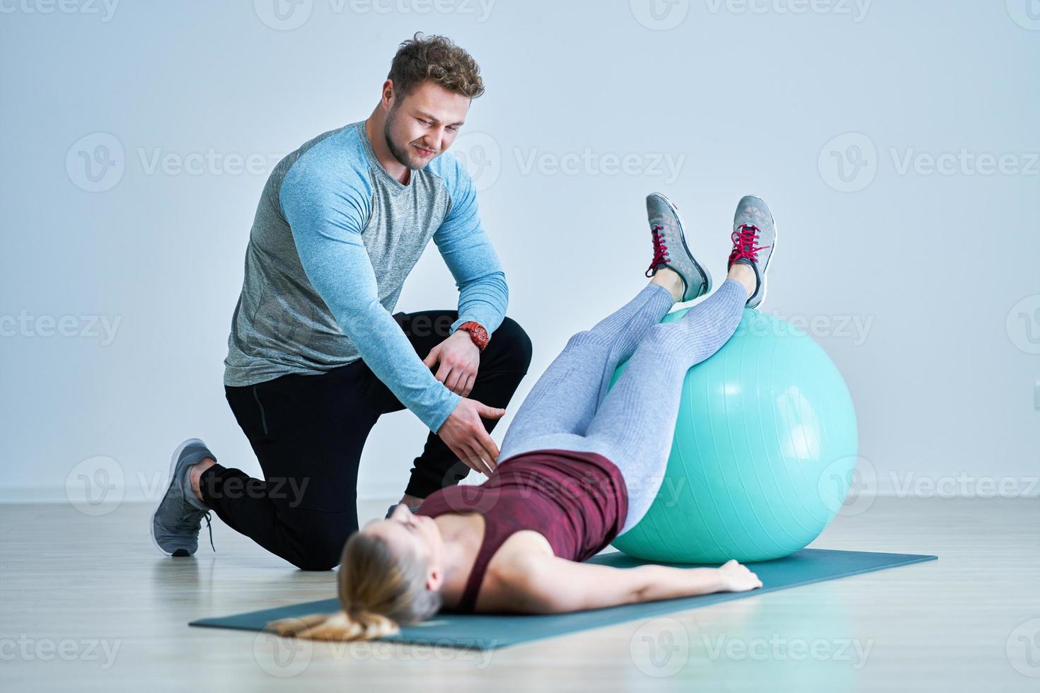 Woman with her personal fitness trainer photo
