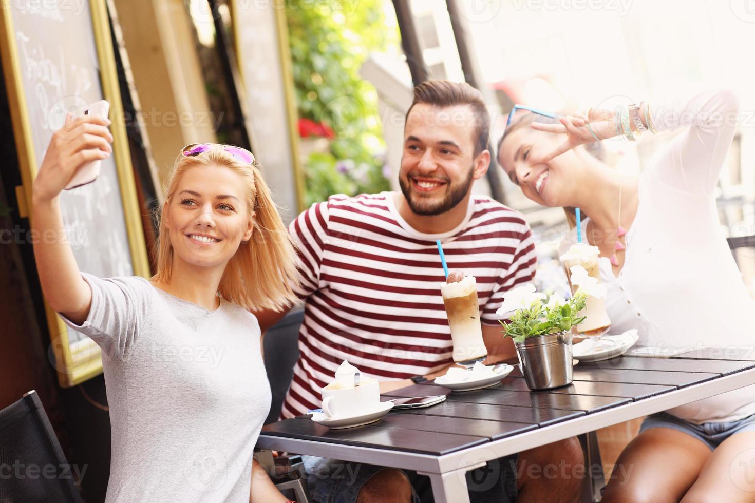 Group of friends taking picture in the restaurant photo