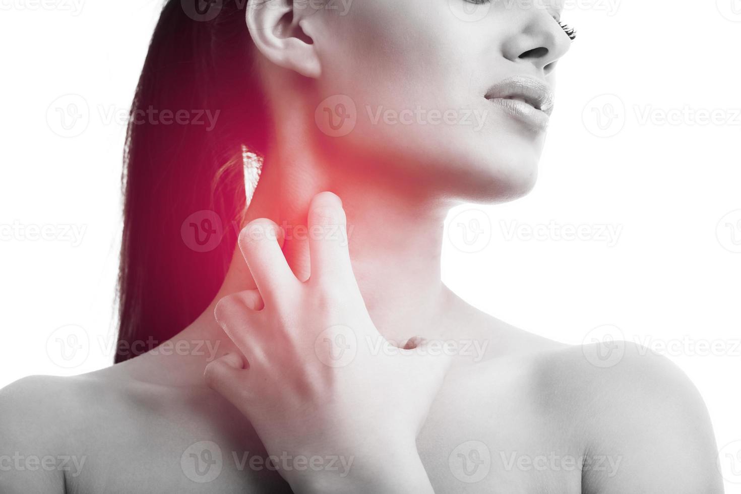 Young woman suffering from sore throat isolated over white background photo