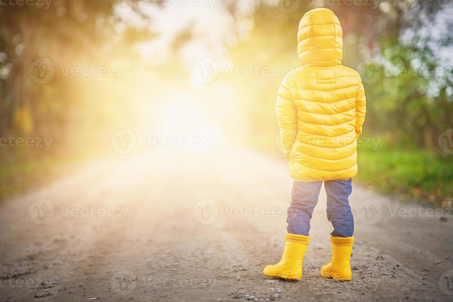 Happy child boy playing outside in autumn photo