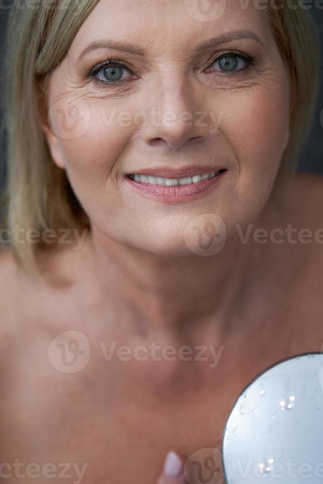 Senior woman taking shower at home photo