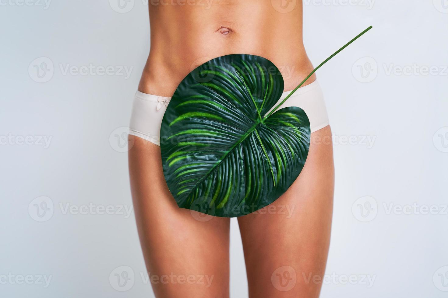 Beautiful adult woman posing naturally with leaves photo