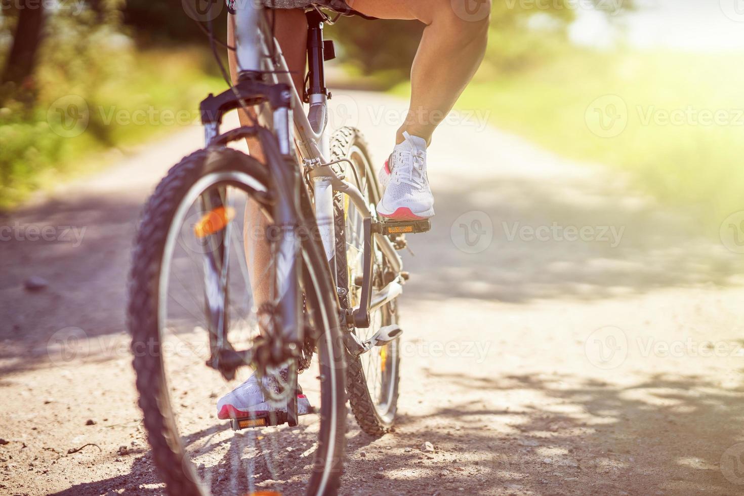 Midsection of a woman on bike photo