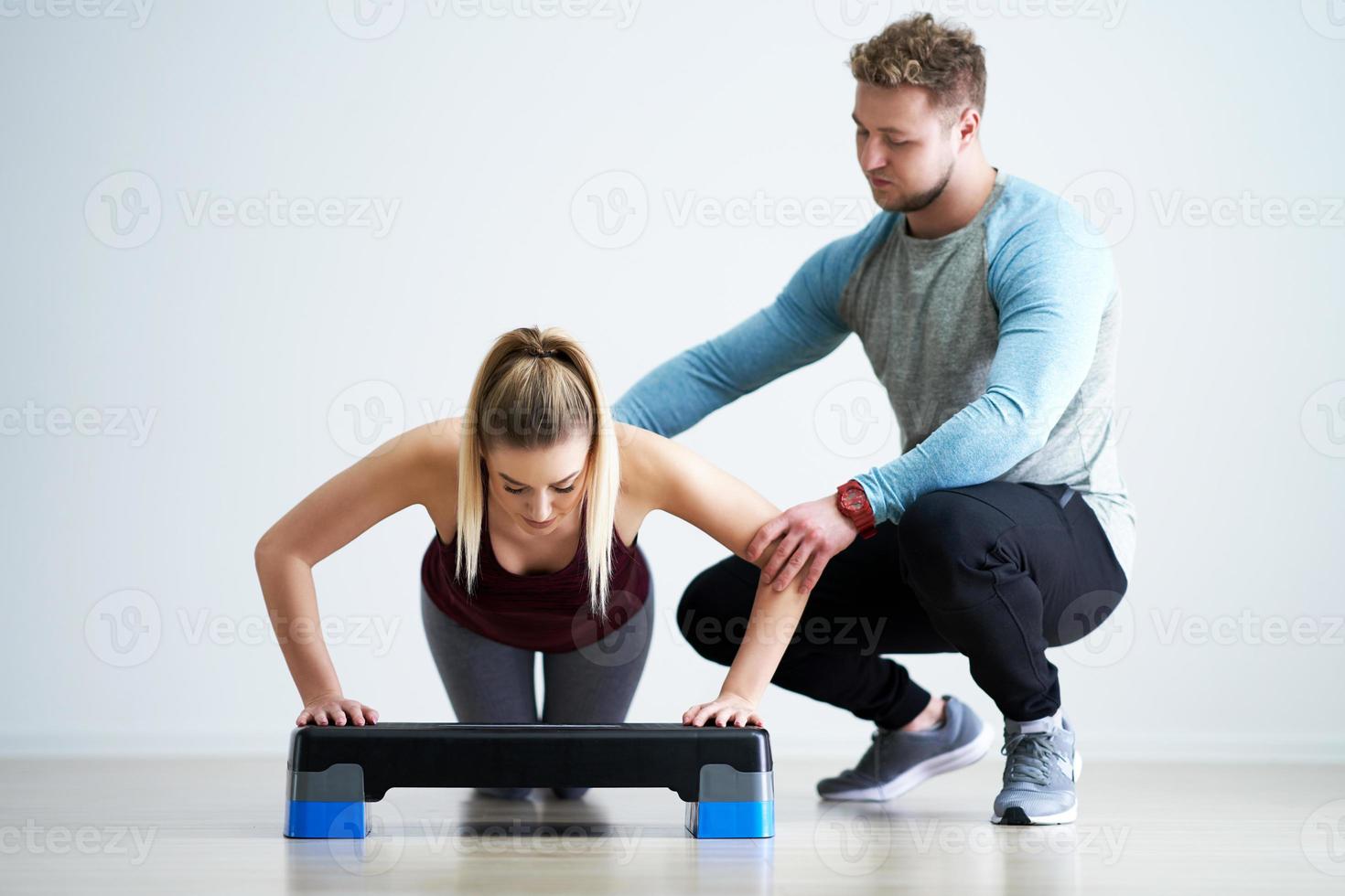 Woman with her personal fitness trainer photo