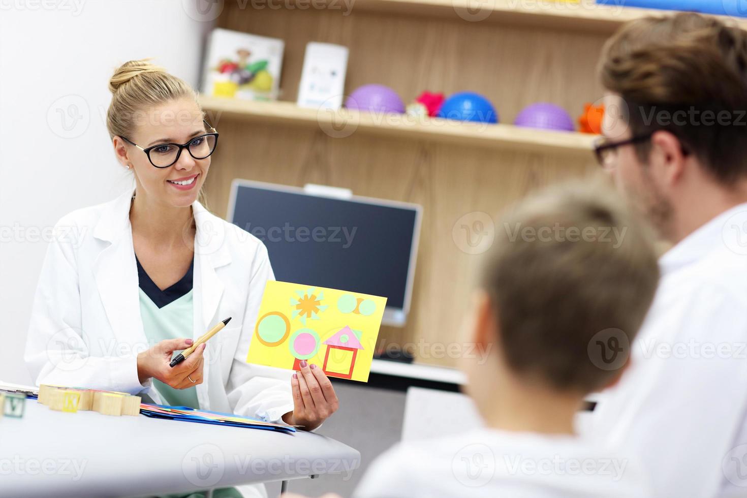 Child psychologist working with family in office photo