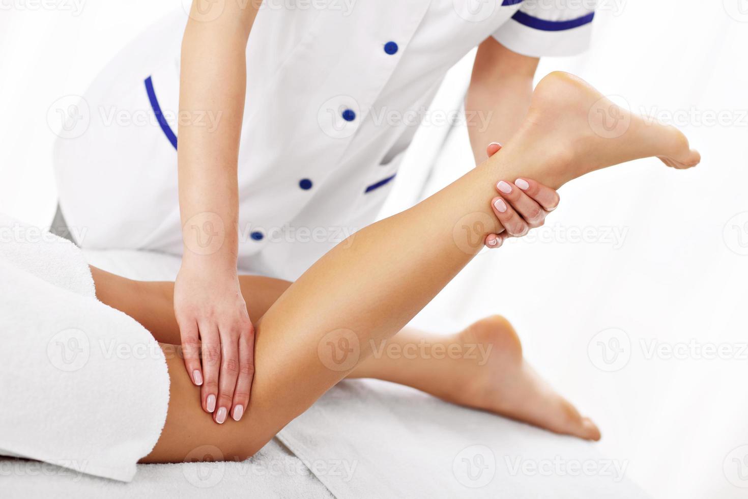 A picture of woman having leg therapy photo