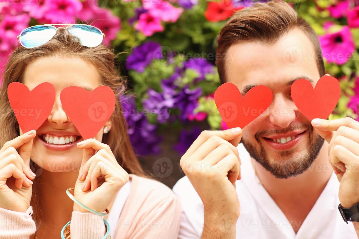 Young romantic couple covering eyes with hearts 15855527 Stock Photo at