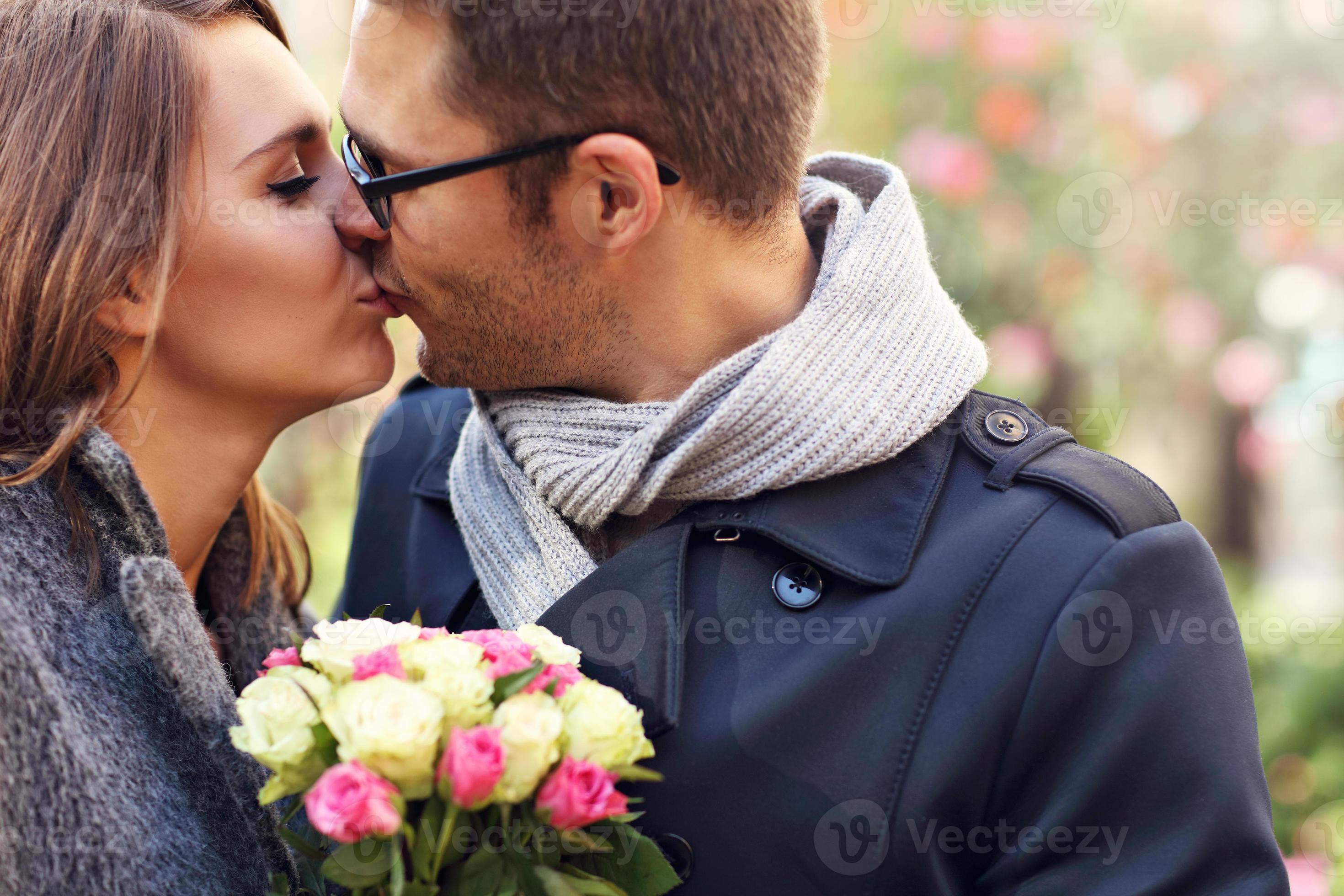 Young couple with flowers kissing in the park 15855653 Stock Photo at