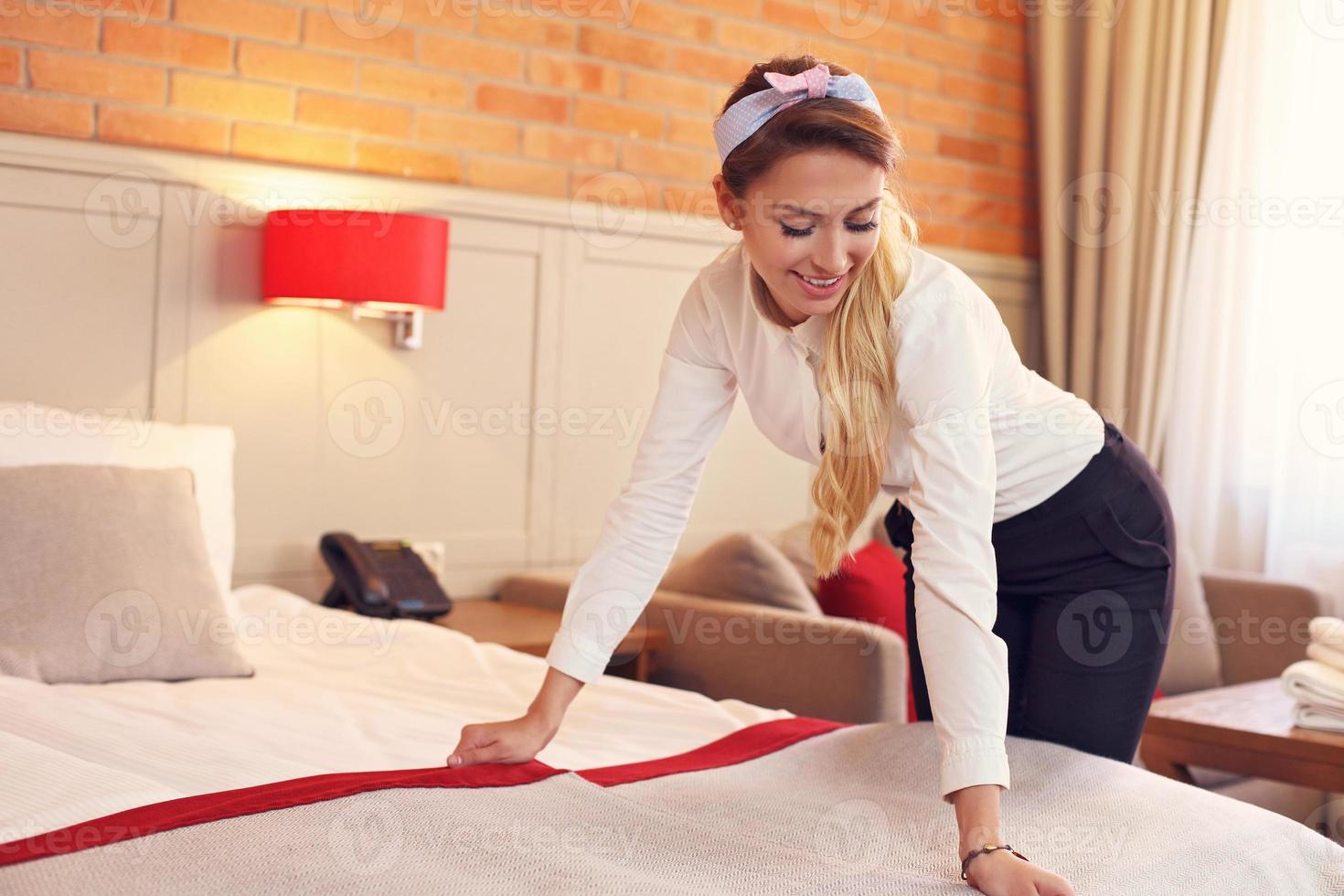 Maid preparing hotel room photo
