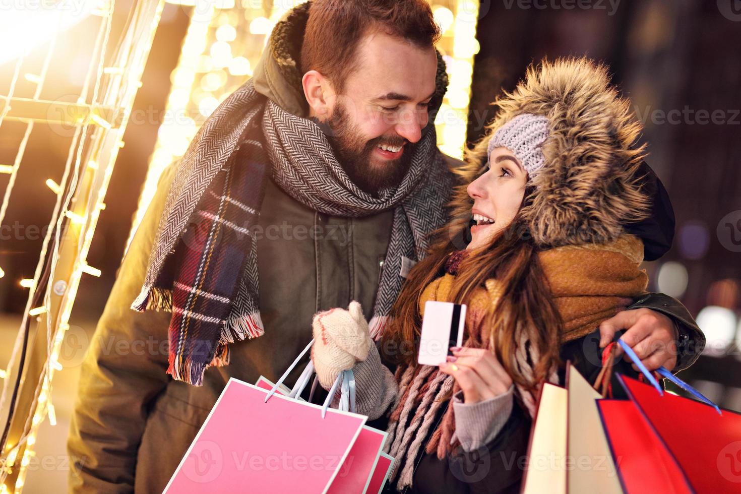 Adult couple shopping in the city during Christmas time photo