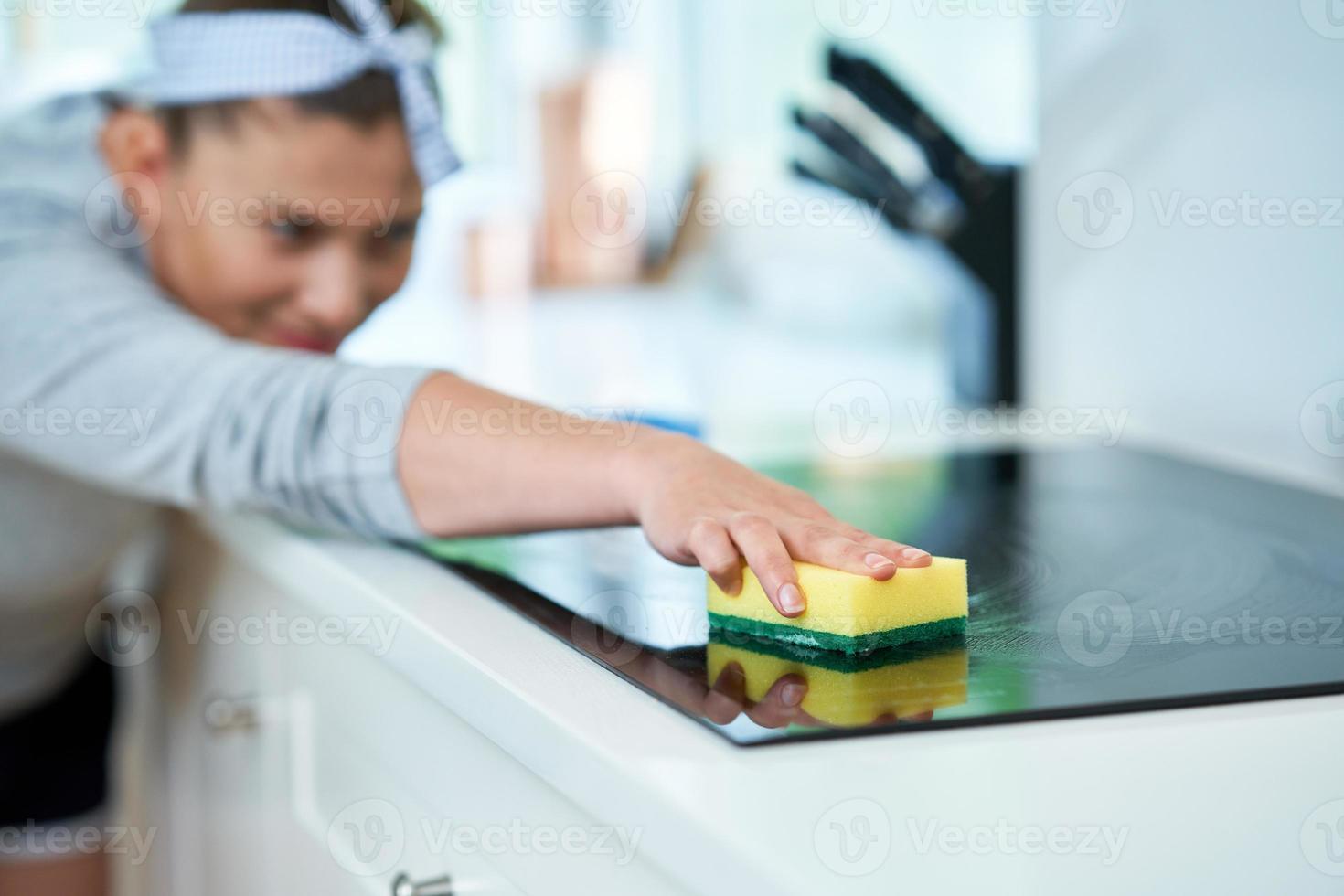 Young woman cleaning dirt in the kitchen photo