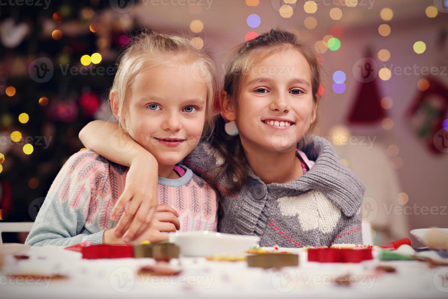 Happy little sisters preparing Christmas biscuits photo