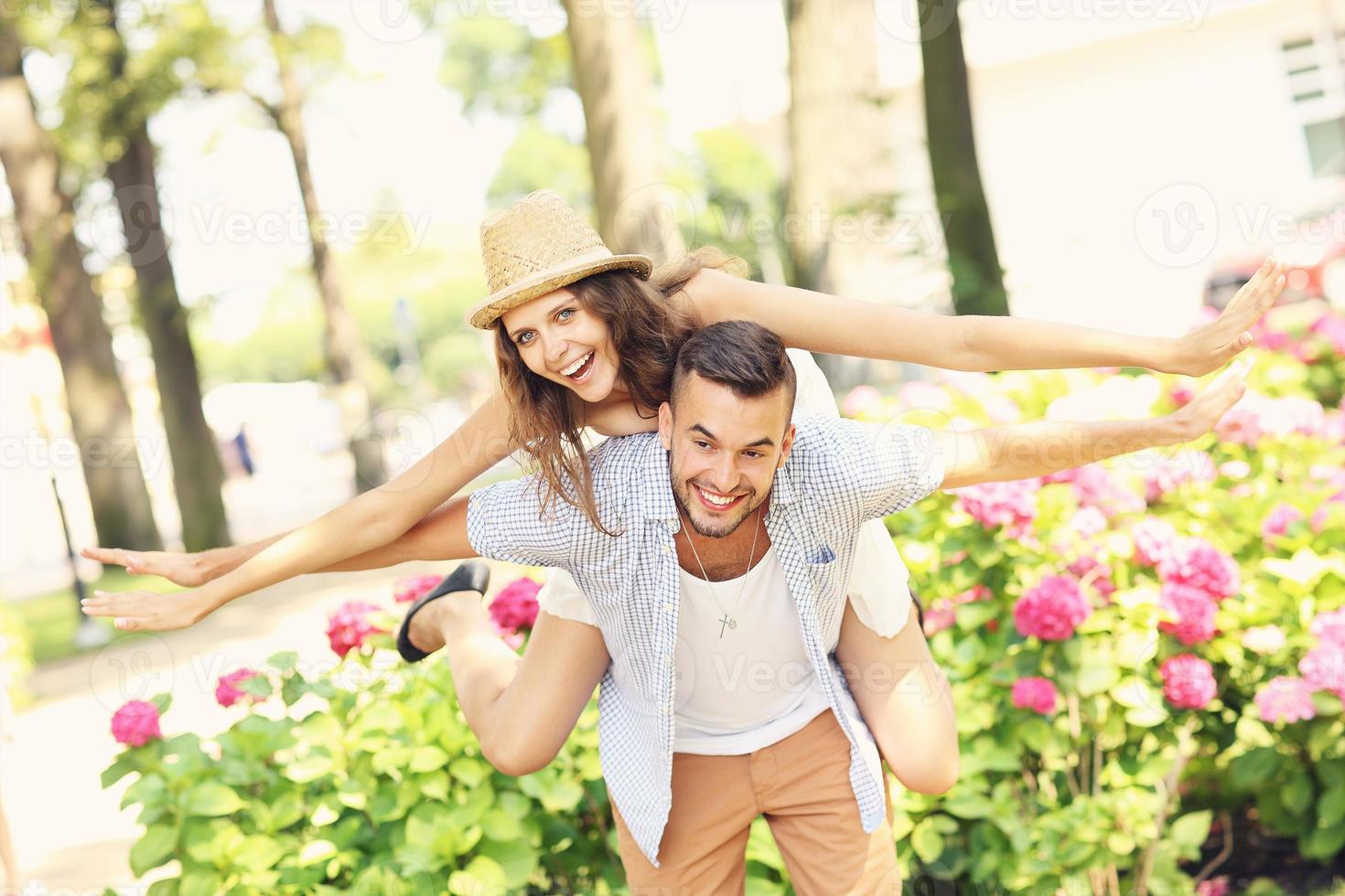 Young couple doing piggyback in the park photo