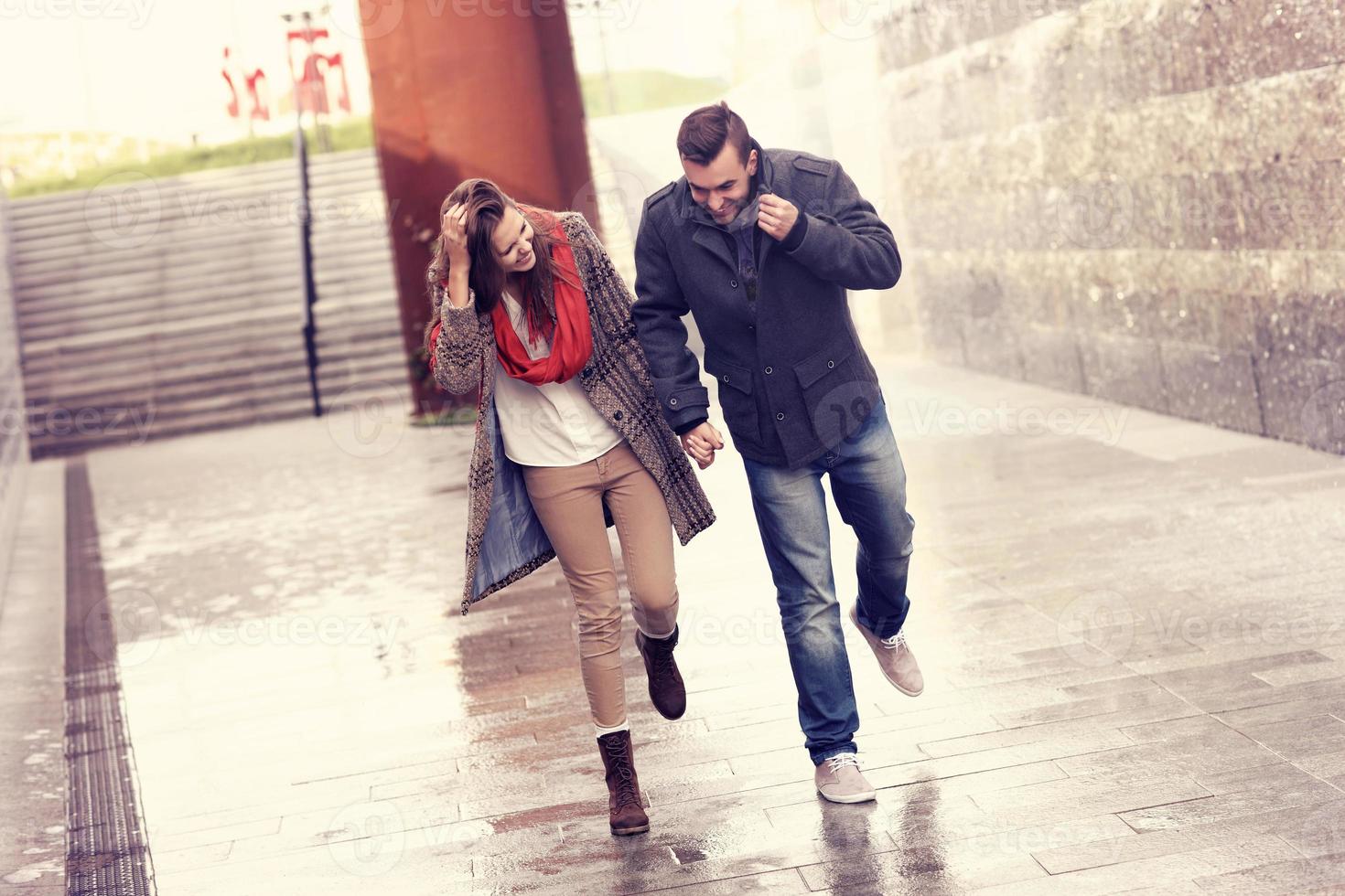 Couple running in the rain photo