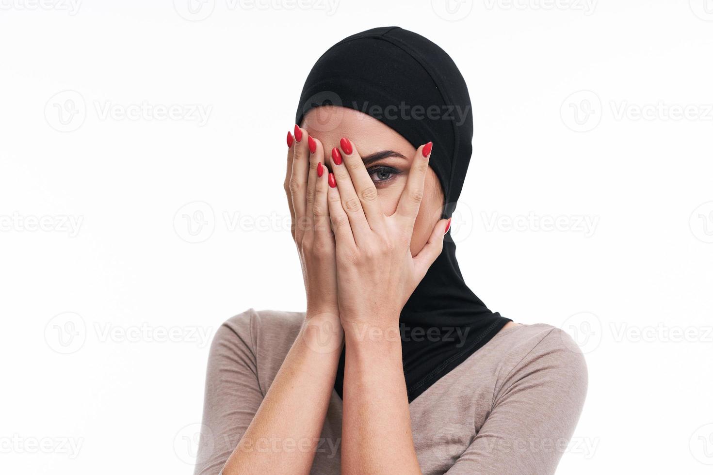 Scared muslim woman over white background photo