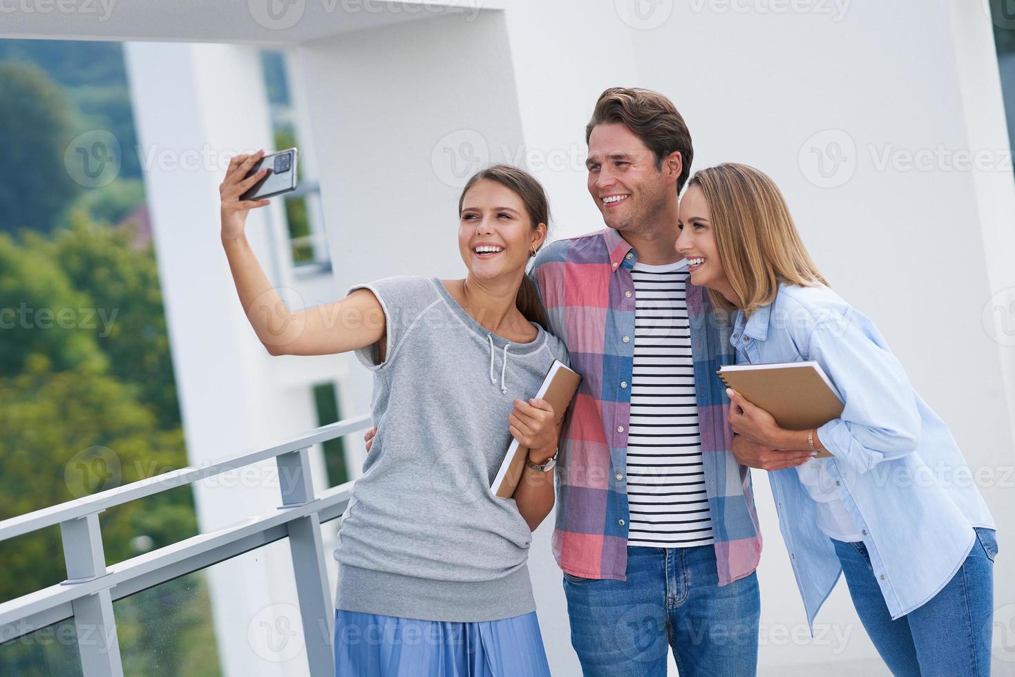 Group of students using smartphone in the campus photo
