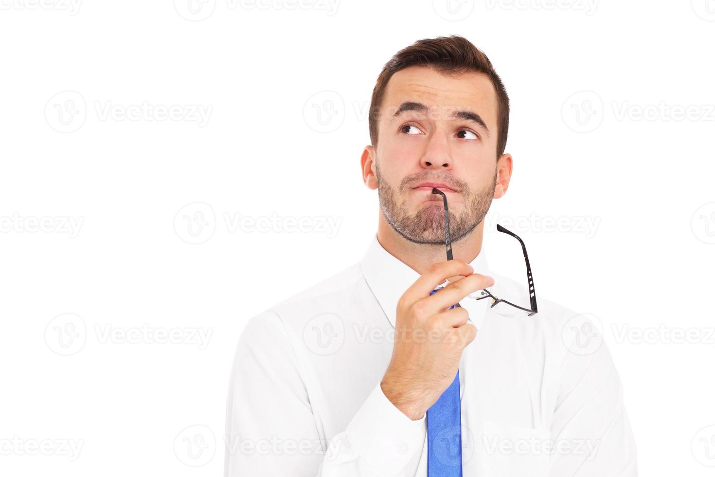 Young businessman thinking over white background photo