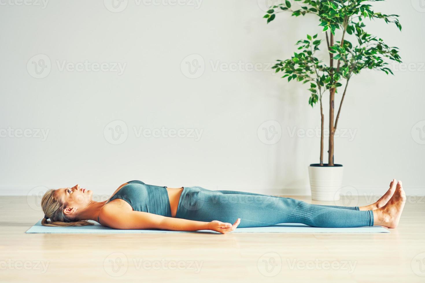 Adult woman practising yoga at home photo