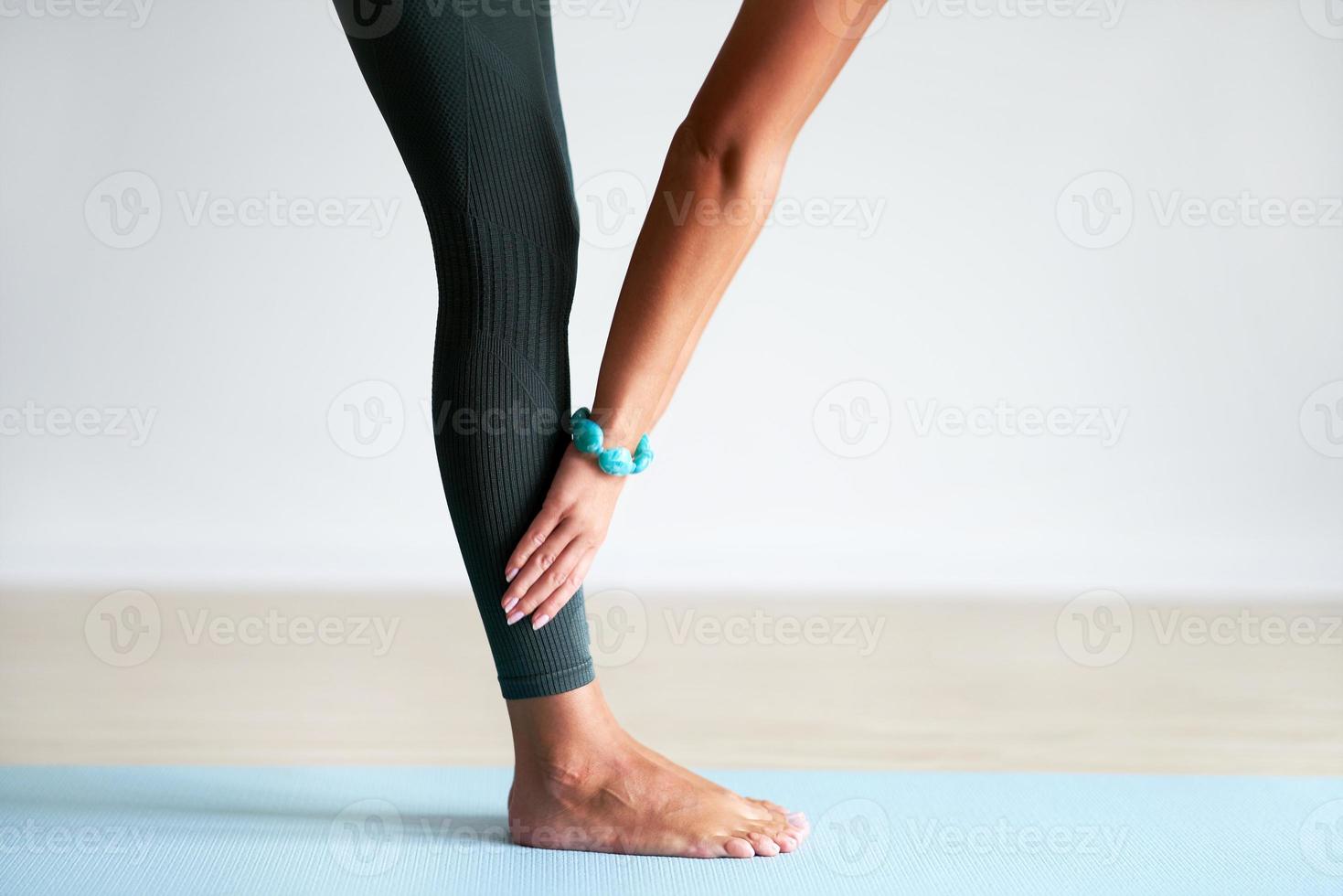 Adult woman practising yoga at home photo