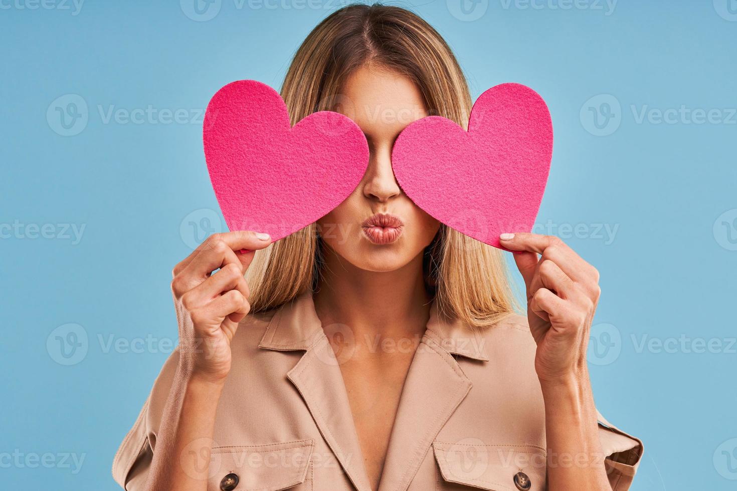 Beautiful adult woman posing over blue background photo