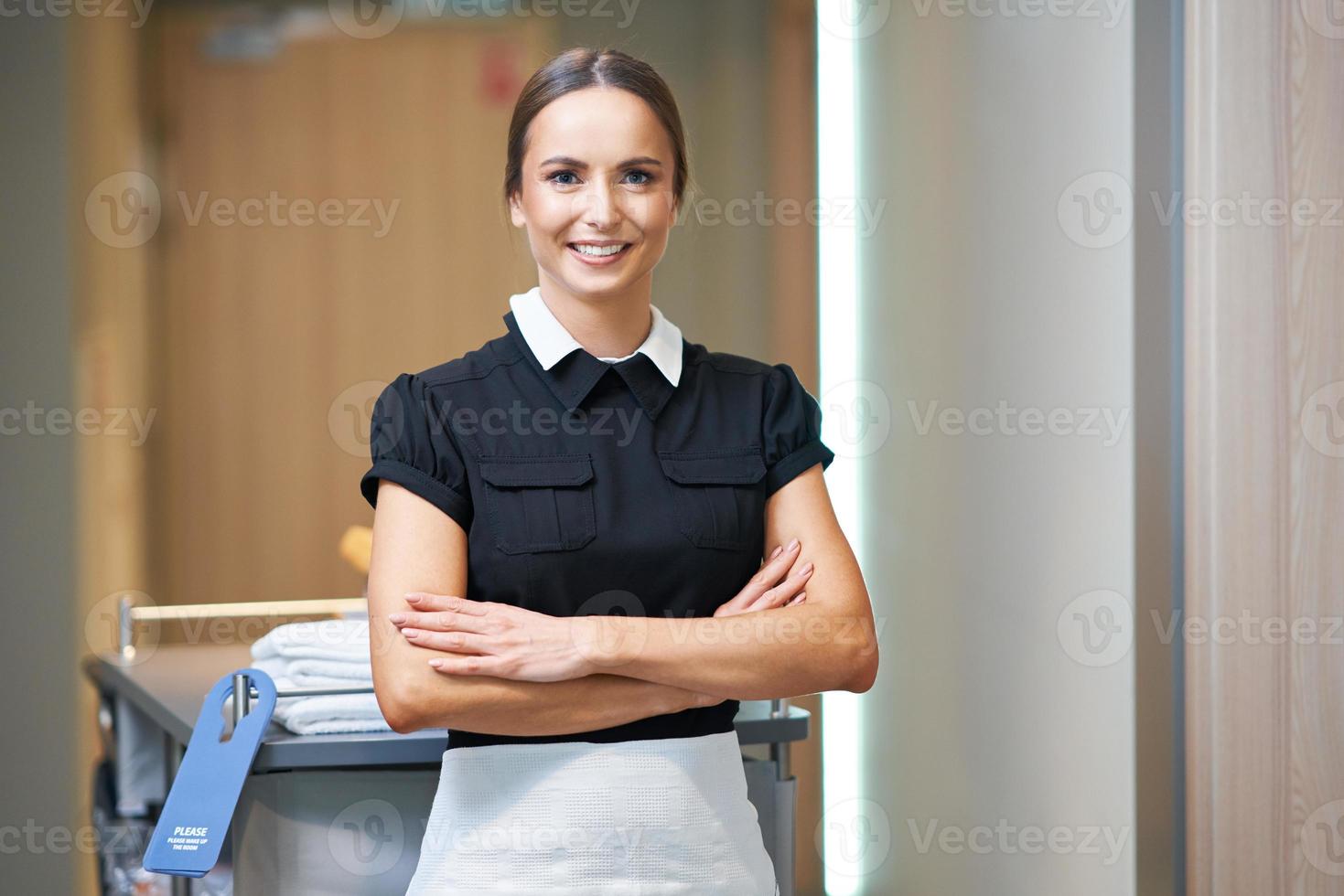 Maid walking in hotel corridor photo