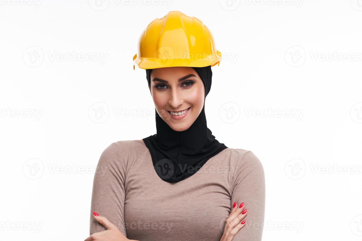 Muslim woman in helmet over white background photo