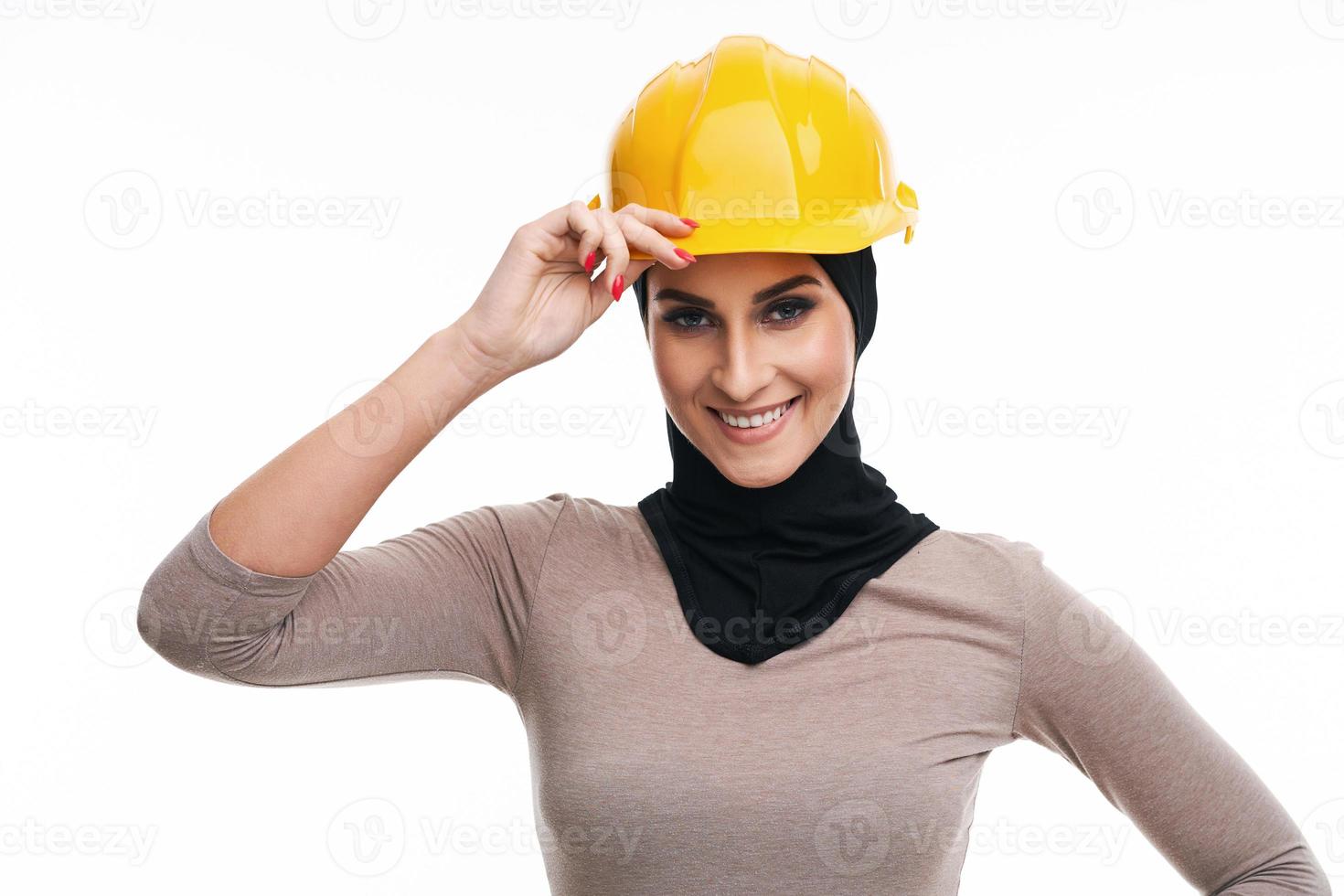 Muslim woman in helmet over white background photo