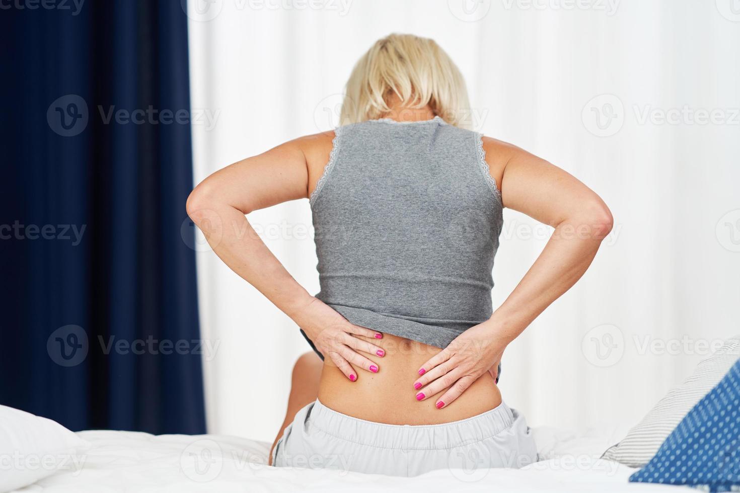 Adult woman feeling unewll suffering from backache pain photo