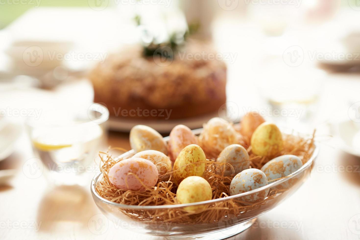 Easter cake and eggs on table photo