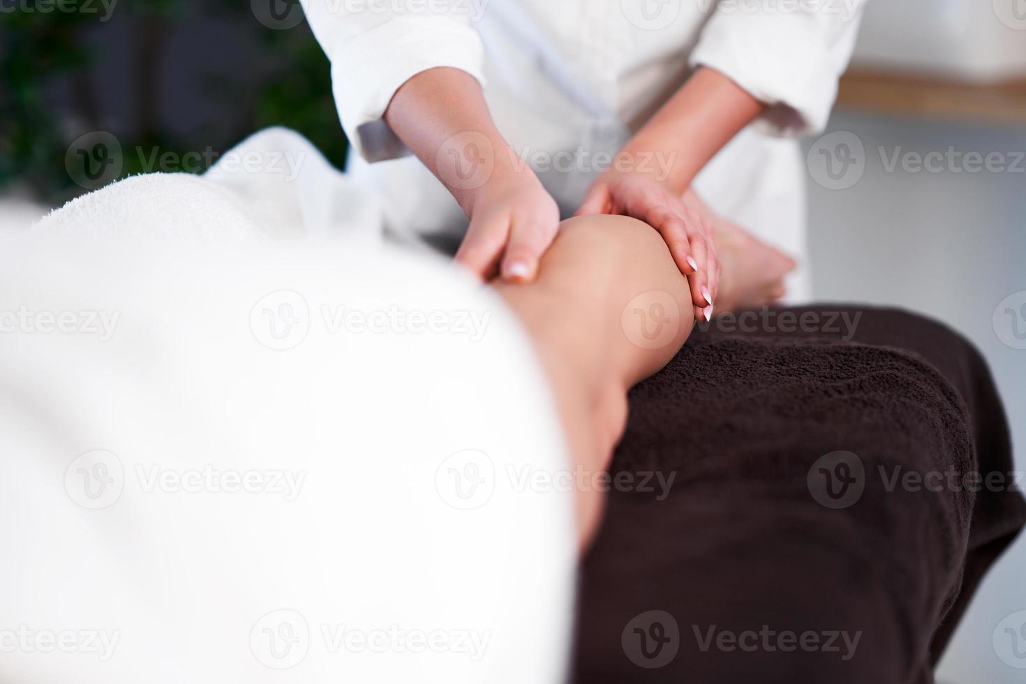 Relaxed woman receiving a leg massage photo