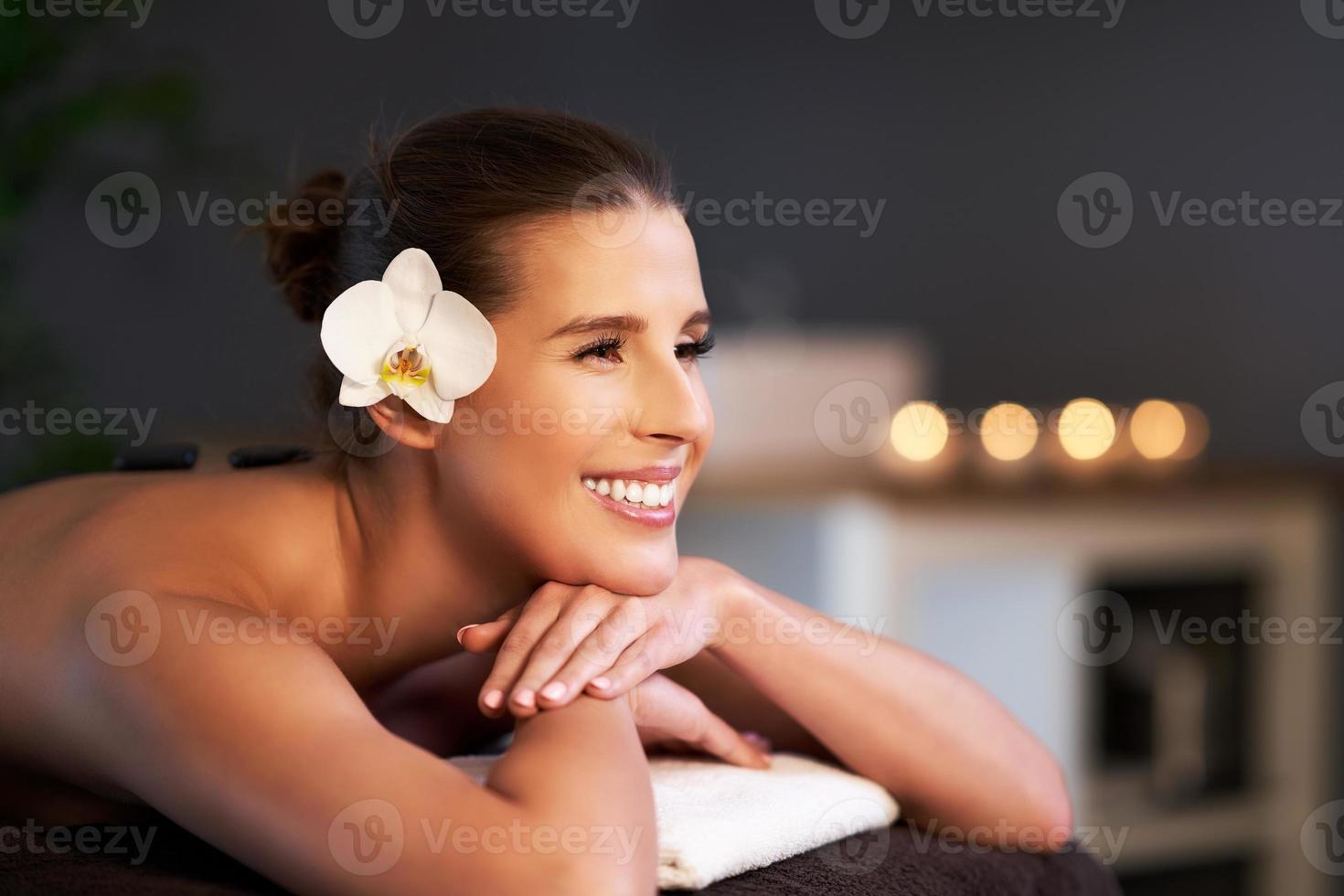 Relaxed woman receiving back massage photo