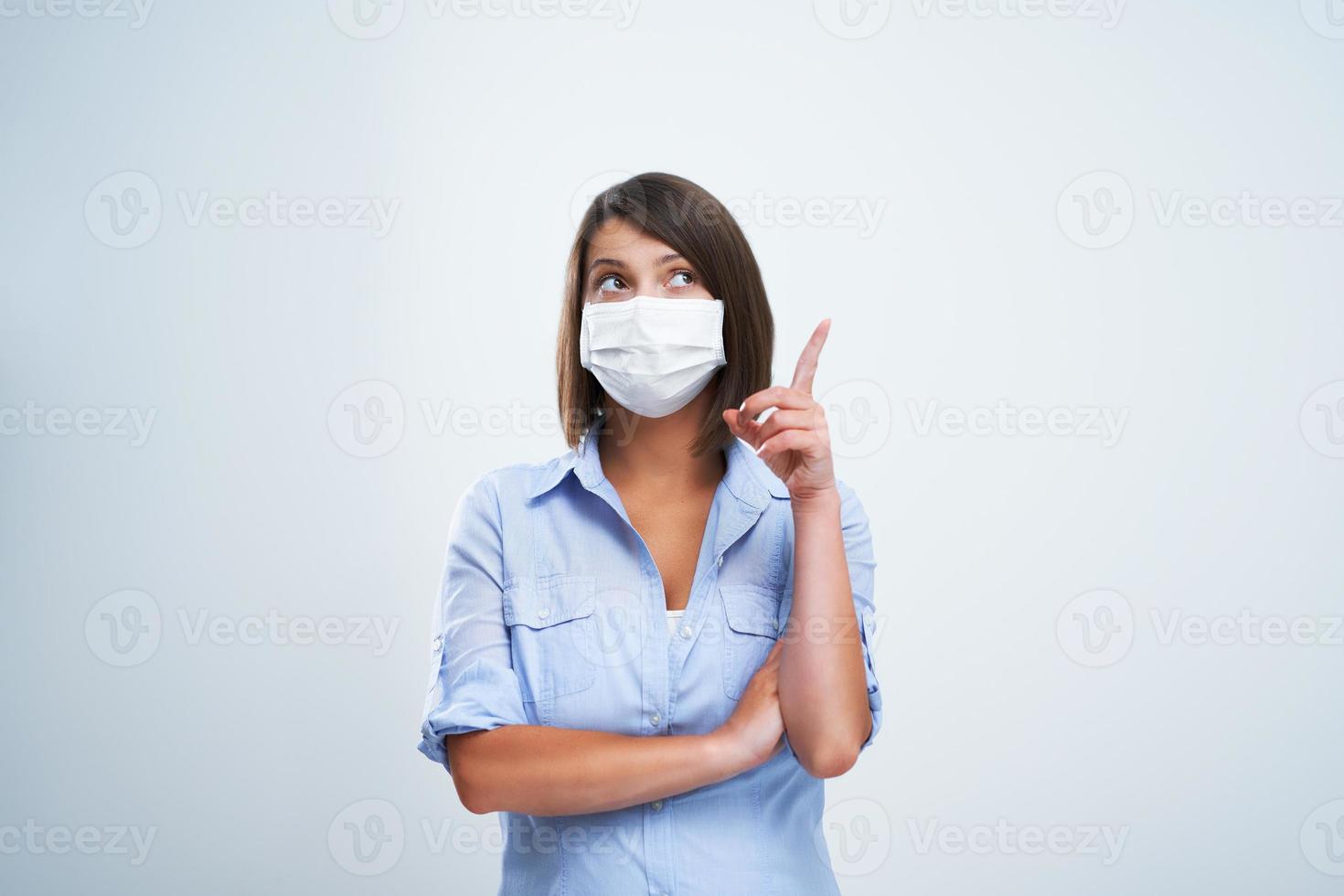 Attractive woman wearing protective mask isolated over white background photo