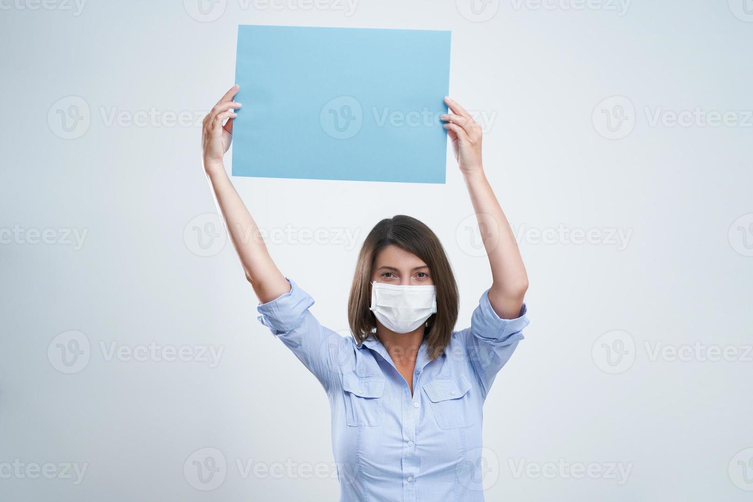 Attractive woman wearing protective mask isolated over white background photo