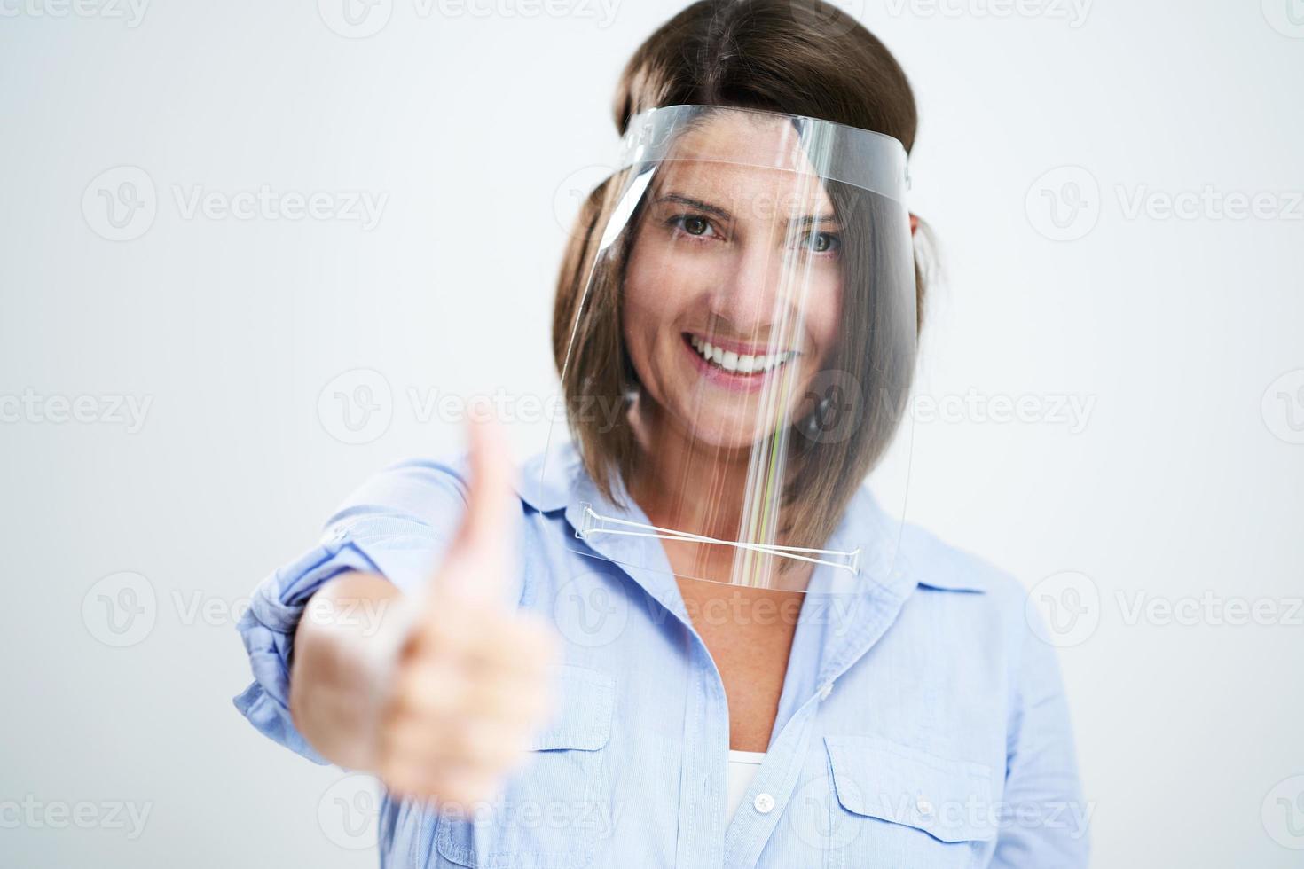 Attractive woman wearing protective shield isolated over white background photo