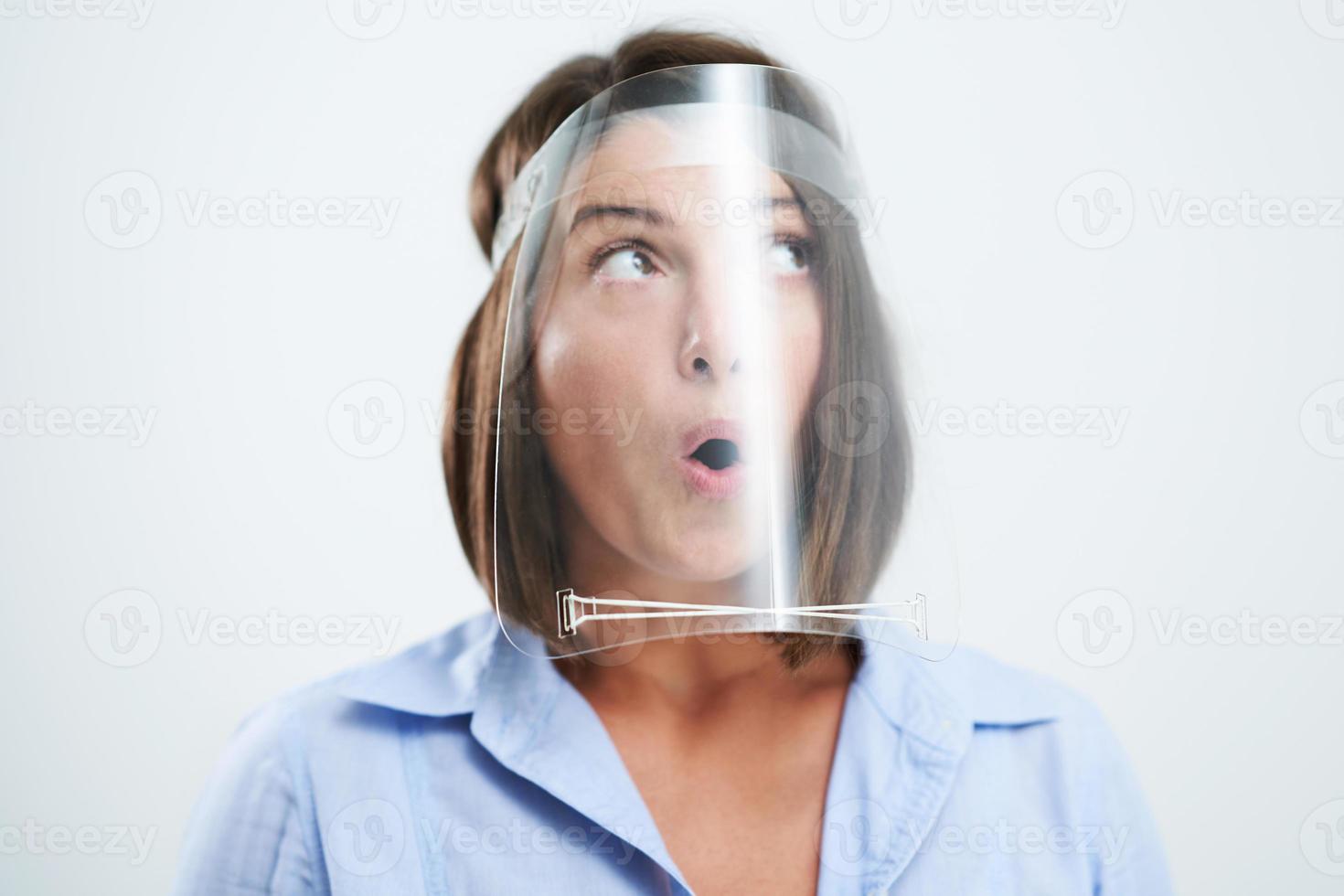 Attractive woman wearing protective shield isolated over white background photo