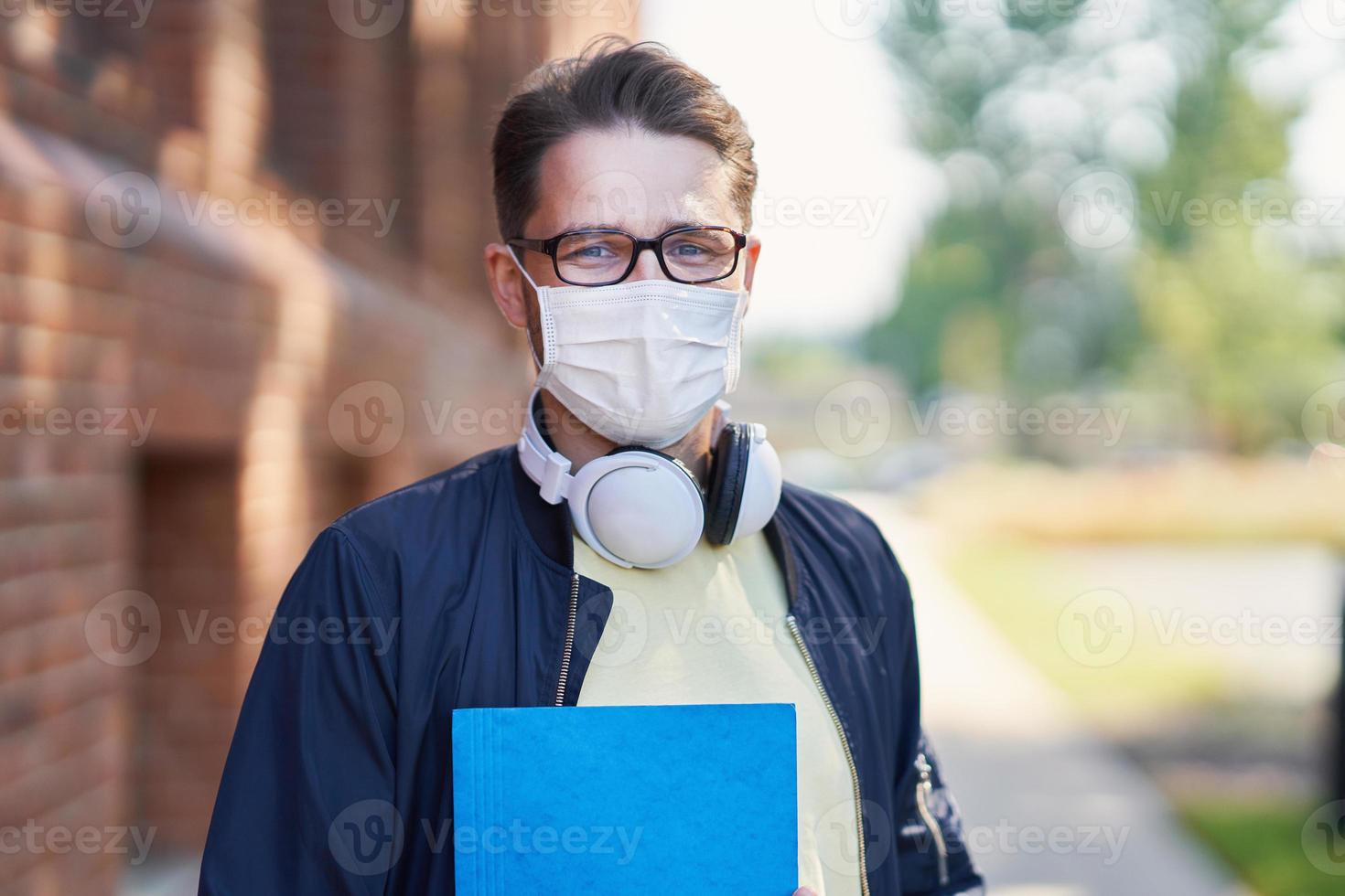 Male student in the campus wearing maskk due to coronavirus pandemic photo
