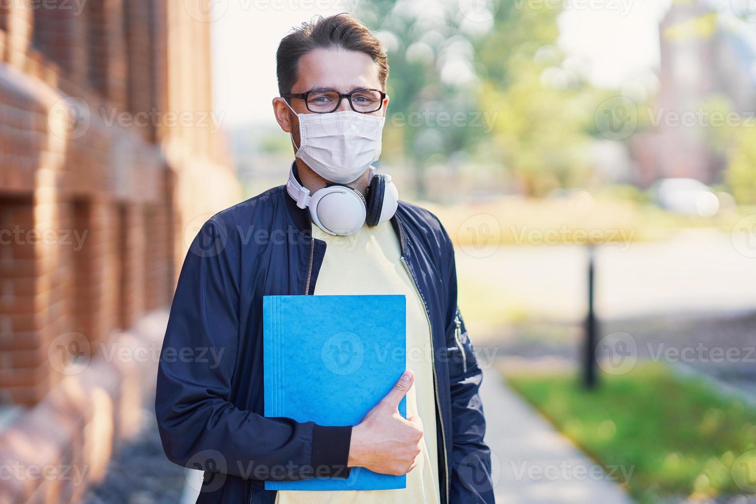 Male student in the campus wearing maskk due to coronavirus pandemic photo