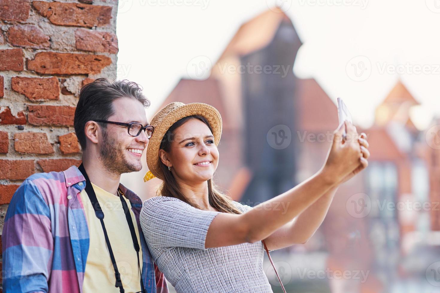 Adult happy tourists sightseeing Gdansk Poland in summer photo