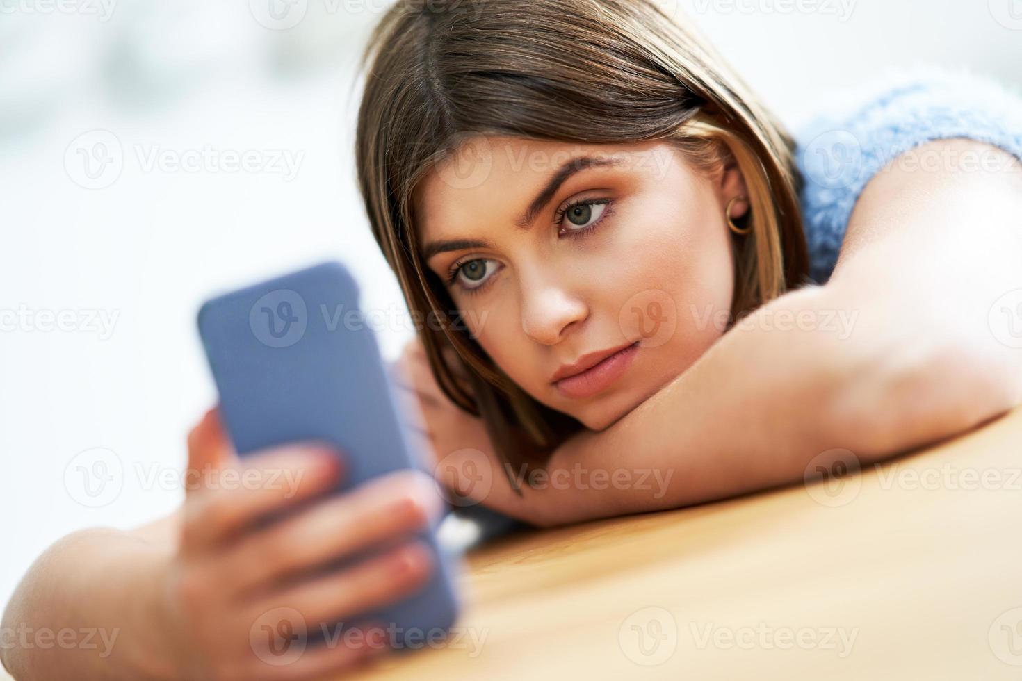 Teenage girl texting at home photo